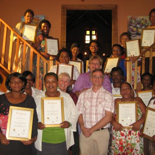 Teachers with certificates at the graduation ceremony